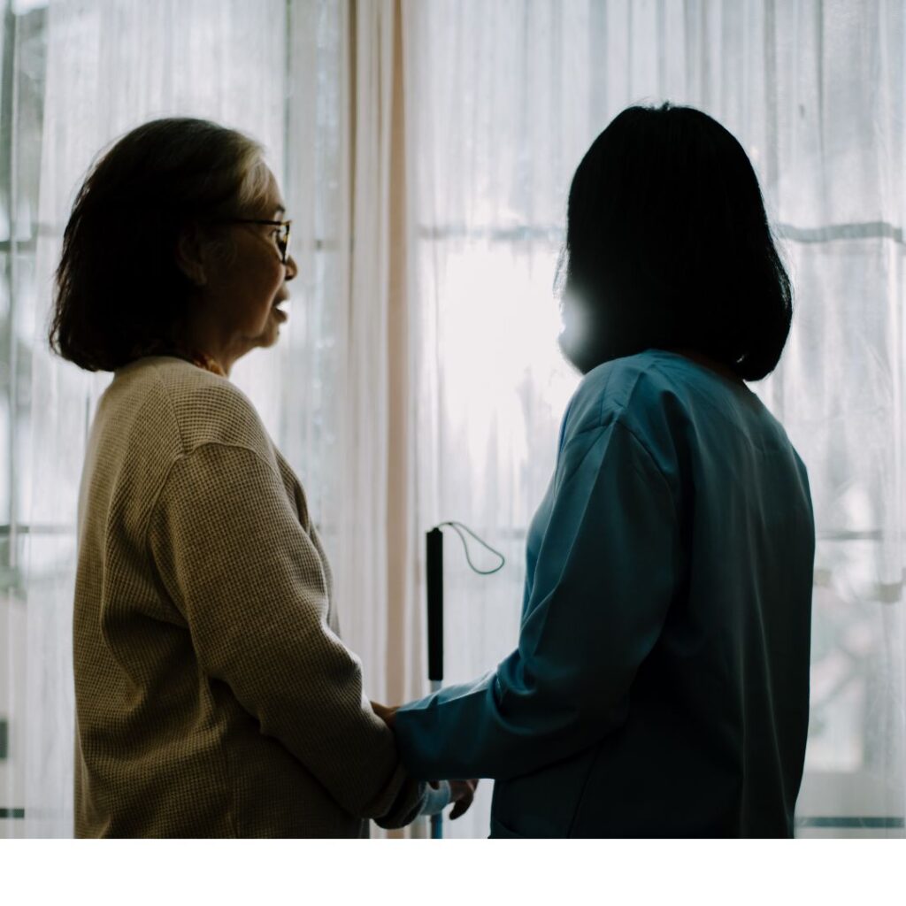 Carer and Client looking out of the window - Live in Care. Short-term care